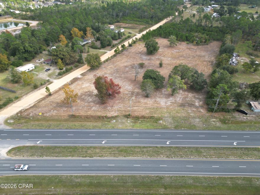 This 7.9± acre commercial property offers a rare opportunity to secure a highly visible site directly on US Highway 77 in one of Bay County's fastest-growing corridors. With approximately 410 feet of highway frontage, this corner parcel provides excellent exposure and access for future development.
The property features two access points -- one directly from Highway 77 and a secondary entrance from Briggs Lane -- offering flexibility for traffic flow, customer convenience, or multi-tenant development. Its corner location further enhances visibility and accessibility.
Located in Southport, just three miles north of Lynn Haven and Panama City, the property is surrounded by established neighborhoods and increasing residential development in the area. As the population continues to grow, demand for convenient retail, service, medical, and professional businesses is expected to follow.
This site would be well suited for a neighborhood retail center, restaurant, medical offices, contractor services, equipment sales, storage facility, or other commercial ventures that benefit from strong traffic counts and easy access. The neighboring sand pit also supports ongoing construction activity in the region.
With strong highway exposure, dual entry points, and continued growth surrounding the site, this 7.9± acre parcel offers flexibility and long-term potential in a thriving location.
Position your business where growth is already underway! Contact us today for more information.  
Key Features:
*Development-ready acreage
* In the direct path of expanding commercial and residential development 
* Near established neighborhoods, new communities, and a planned retirement development.
* Just 3 miles to Lynn Haven/Panama City and approximately 10± miles to Northwest Florida Beaches International Airport.