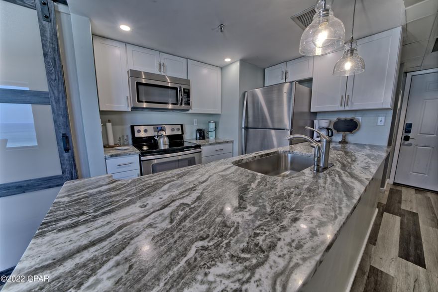 CURRENTLY UNDER CONTRACT, SELLER ACCEPTING BACKUP OFFERS. Gorgeous updated PENTHOUSE 1BR W/ BUNK ROOM unit with vinyl plank flooring throughout, barn doors, stainless kitchen appliances, new Electrical Panel, all new windows and sliding glass doors. Amazing GULF VIEW from the living room and balcony.  Rental history of $50K+. Sunbird buildings have been renovated including new exterior paint, roof and Pool decks. Sunbird has some of the lowest HOA fees on the beach.**