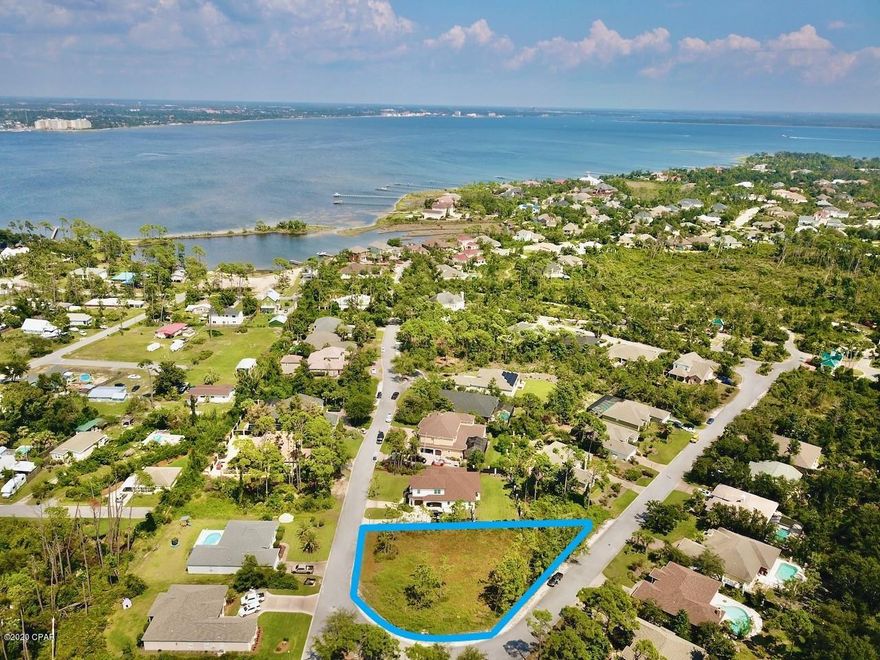 Perfect lot in an established gated community with 24 hour security!! This mostly cleared corner lot boasts .33 acres in one of Bay County's premier waterfront communities. Perfect for your luxury home complete with the potential for a circle driveway. Located closely to some of the best schools and dining that Panama City Beach has to offer and of course the World's Most Beautiful beaches! For additional information or to discuss potential floor plans, call today.