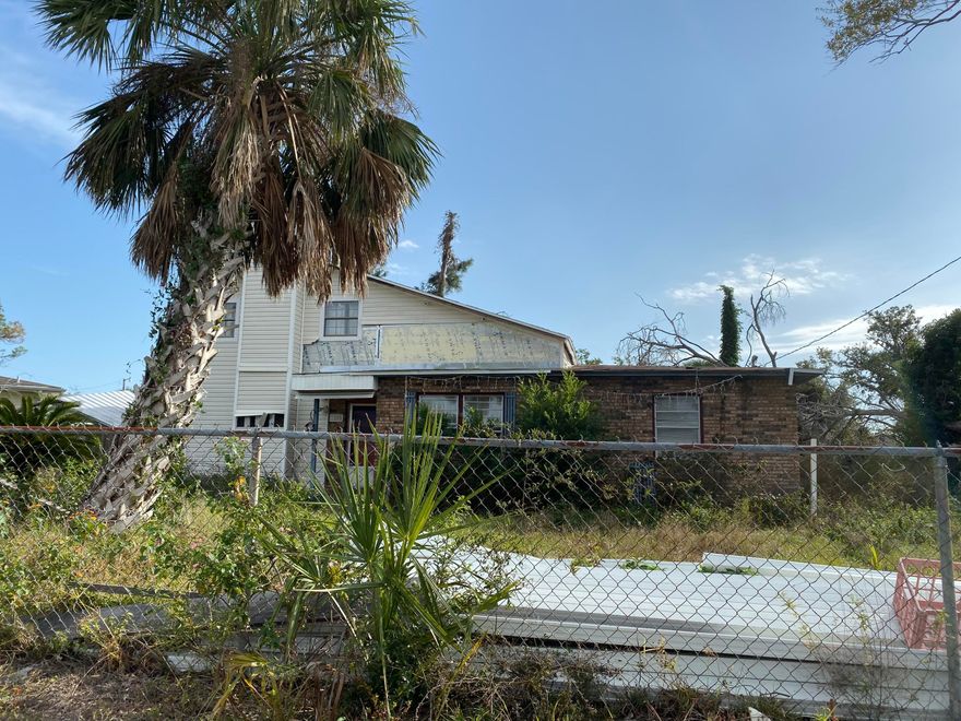 Back on Market - Great lot in St. Andrews.  House is heavily damaged and has no value.  House was originally 2 bedroom brick house and was added onto with additional 2 bedrooms.  There are also several large storage buildings and sheds on property.  Trees hit the house and is assumed there is structural damage.