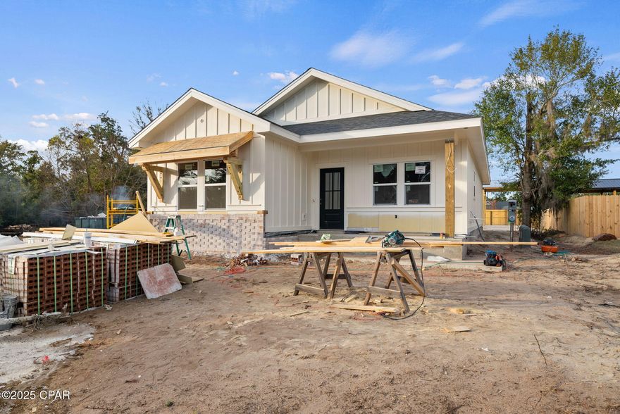 This new construction home is being built and filled with upgrades including stunning custom millwork throughout! Estimated completion is mid to late Spring 2026. This new construction home is eligible for USDA, FHA, VA and conventional loans and the perfect opportunity to own your first home, upgrade your lifestyle or retire in style. 100% financing available for qualified Buyers!

No expense is spared in the construction of this gorgeous 3 bedroom, 2 bath home designed and built by Southern Belle Construction. This home is a single level with a split floorpan, vaulted ceilings throughout the great room area and offers a covered back porch that spans the width of the home. Sit on your covered back porch overlooking a spacious back yard and a 16' x 24' pole barn that is perfect for boats, RVs, cars or a shop. This home sits with an excellent proximity to a public boat ramp which will allow you to live the waterfront lifestyle we love in Florida!

The pole barn has 100 amp electrical and also offers the potential to be converted into a garage. This property also has a generous sized backyard and you'll love the ability to add a pool or make the pole barn your own shop or man cave!

Step inside this new construction beauty with an earthy, organic vibe. You'll be wow'd by the soaring vaulted ceilings, LVP flooring throughout and soaring ceilings. The kitchen is open and provides a spacious 6' island with seating, generous pantry, glowing quartz countertops and an earthy mix of millwork using local saw mill lumber throughout including wainscoting, beams, custom fireplace mantel and tray ceilings in the primary bedroom. Southern Belle Construction utilizes a variety of natural wood including juniper, rough cut pine, deadwood cypress and live edge cypress to create a custom gem at an incredible price point!

This well-renowned builder is known for her hand-crafted wood accents and will provide custom shaker cabinetry, upgraded appliances and a stunning fireplace making this timeless home stand apart from others! Brushed gold plumbing and designer lighting will be consistent throughout this home giving a contemporary, modern design in this new construction beauty. 

Step into the living room and warm up by the fireplace under beautiful vaulted ceilings. Open the glass door and enjoy the breezes from the back yard and an extended living area with a covered, bricked back porch that is perfect for entertaining! The primary suite stands out with tray ceilings, overlooks the back yard and offers an upgraded tray ceiling, large windows, spacious ensuite bath including a walk-in shower, soaking tub, double vanities and a generous sized walk-in closet. 

With an ideal split floor plan, the two guest bedrooms are toward the front of the home, just off the foyer. Both give spacious closets and a shared bathroom  easily accessible by the hallway. LVP flooring is found throughout the home for easy cleaning! The laundry and mudroom is near the entry way and brings light in from the front yard. 

This home sits on a deep lot and gives great curb appeal with an upgraded paver driveway, beautiful and easy landscaping. The exterior will feature a mix of tumbled magnolia bay brick and indigo blue and cream ship lap with shake Hardie and juniper wood accents.

A one-year builders warranty will convey with the home. Don't miss your opportunity to own a new construction home with this many upgrades!! Estimated completion of this home is mid to late Spring 2026...just in time for summer!

*Images are shown from similar home under construction in the same area. Images will be updated throughout construction. Please contact listing agent for additional images or video tour of current state of construction.*