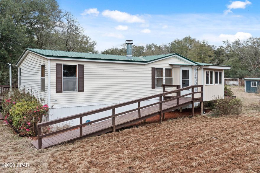 CURRENTLY UNDER CONTRACT, SELLER WILL CONSIDER BACKUP OFFERS - NEED A PLACE THAT CHECKS THE BOXES?  This one will probably check most of the boxes and more.  It is located in the country on over a 3.5 acre corner lot with partial fencing already in place.  There are multiple outbuildings, detached parking areas for recreational vehicles, front and back ramps for accessibility, an enclosed front sitting area, a covered back porch overlooking the pond and... it has a separate private entrance on the back side of the property.  The interior has a spacious open concept, a woodburning fireplace, walk-in closets in every bedroom and a garden tub with a separate shower in the master bathroom.   Contact your favorite realtor today to schedule a showing!