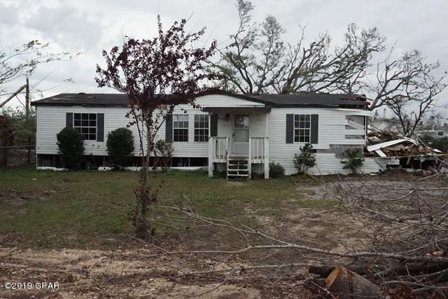 Value is in the land.  Mobile home damaged from hurricane.  Fenced lot with a 12 x 24 shed that does have some damage.  Great lot to build that dream home or put another mobile home.  Convenient to Tyndall AFB and all amenities.