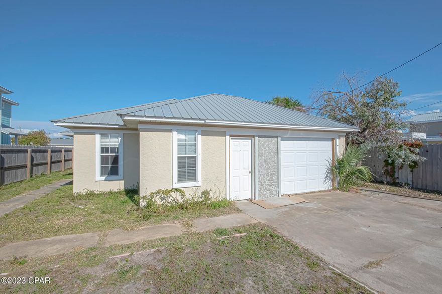 CURRENTLY UNDER CONTRACT, SELLER WILL CONSIDER BACKUP OFFERS This single-family residence is situated just 2 blocks from the beach and offers an incredible opportunity for those looking to personalize and renovate a home to their taste and style.  AN ENTERTAINER'S DREAM! This 3-bedroom, 2-bathroom open concept bungalow boasts a cathedral ceiling and gas burning fireplace in the living area. A breakfast area with sliding glass doors that lead to an 11' x 10' concrete patio which lends direct access to a 24' x 17' L-shaped deck with built in benches.  On the back of the home is a 15' x 12' sunroom to be enjoyed for an evening of entertaining or an afternoon nap.  Location is key and being just a short walk to the beautiful white sand beaches in an area with many restaurants, shopping and entertainment, this property offers not just a home but a lifestyle.  New roof in 2022.  Square Footage Agent measured.  If important, please confirm for accuracy.