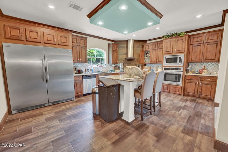 Beautiful, 2019 built, homestead on 5 acres. Almost a full acre of manicured zoysia lawn, 500 foot freshwater well, and large pond suitable for swimming. The acreage is established with mature trees, fruit trees, and grape arbors.  The manufactured home, built in 2019, boasts an impressive 2500sqft with open floor plan, 4 bedrooms, and 3 bathrooms. The home features 2x6 framing, and 9 ft ceilings. The beautiful kitchen features stainless appliances, granite countertops, tiled backsplash, and hardwood cabinets. The main living area features a stone fireplace, and built-in storage shelves. Off of the living and kitchen area is a large dining area. There is a secondary living area/bonus room off of the dining area.  The master bathroom features a garden tub, walk-in tiled shower, double vanity, and linen closet. All bedrooms feature nice sized closets, plenty of natural light, and fresh carpet. The home also features a large laundry room with washer and dryer hook ups, mud room area, and utility sink.  Outside this beautiful home are a pump house, chicken coop, and a 30x30 detached garage with full electric service, hurricane rated roll up doors, and a 300 sqft loft. This awesome home is located just 15 mins from Publix in Crestview, and less than 30 mins from Duke Field/Camp Simons.