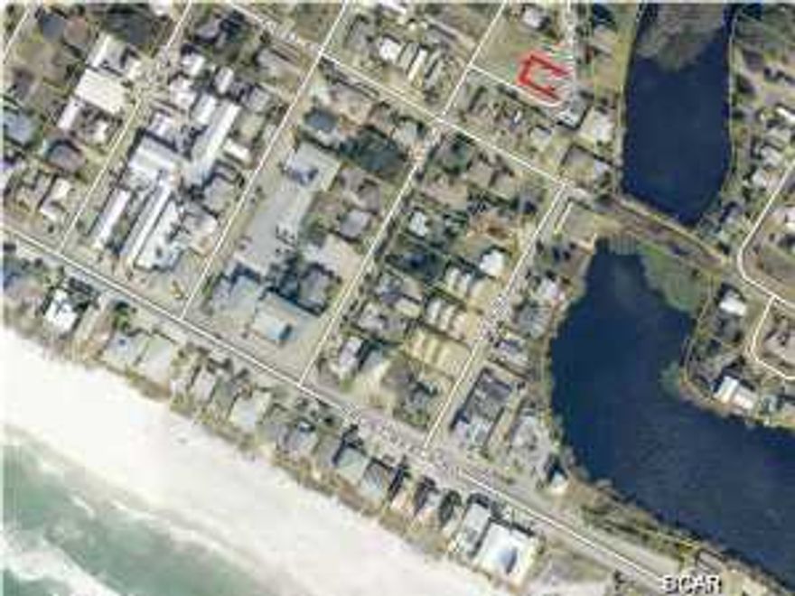 ONE Block to Panama City West Beach. Sewer is located on Claude Cir. Owner can build height up to 45 feet. Possible lake and gulf views. What a location for this price!