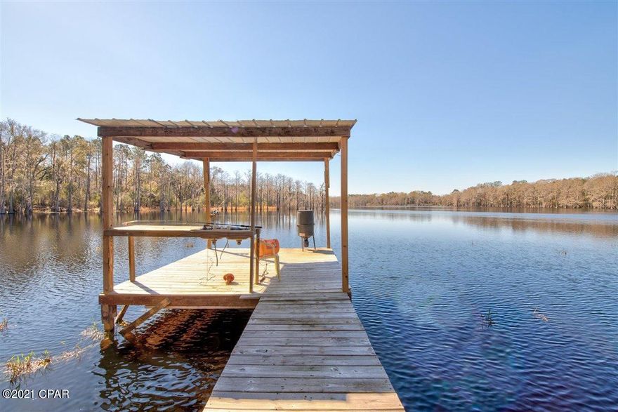 An outdoor-lover's paradise! Hang out at the dock and catch fish, 4-wheel through the woods, or sit in one of the 4 shooting houses and hunt the loads of deer that visit the area. This 40-acre property is on a very private, stocked, 40-acre Brock Lake! There are only 2 other houses on the lake, but no one ever uses it, so it's basically your own private lake! There is 26.5 acres of planted pine, and also a few fruit trees on the property. There is a 60x30 barn (with power, septic, well), and a 60x32 pole barn with 17' high walls, perfect for your RV! The barn has a small 1 bedroom apartment that the owner built to stay in while visiting, but can be lived-in while you are building the house of your dreams!  The apartment is currently occupied, and all is sold As-Is.