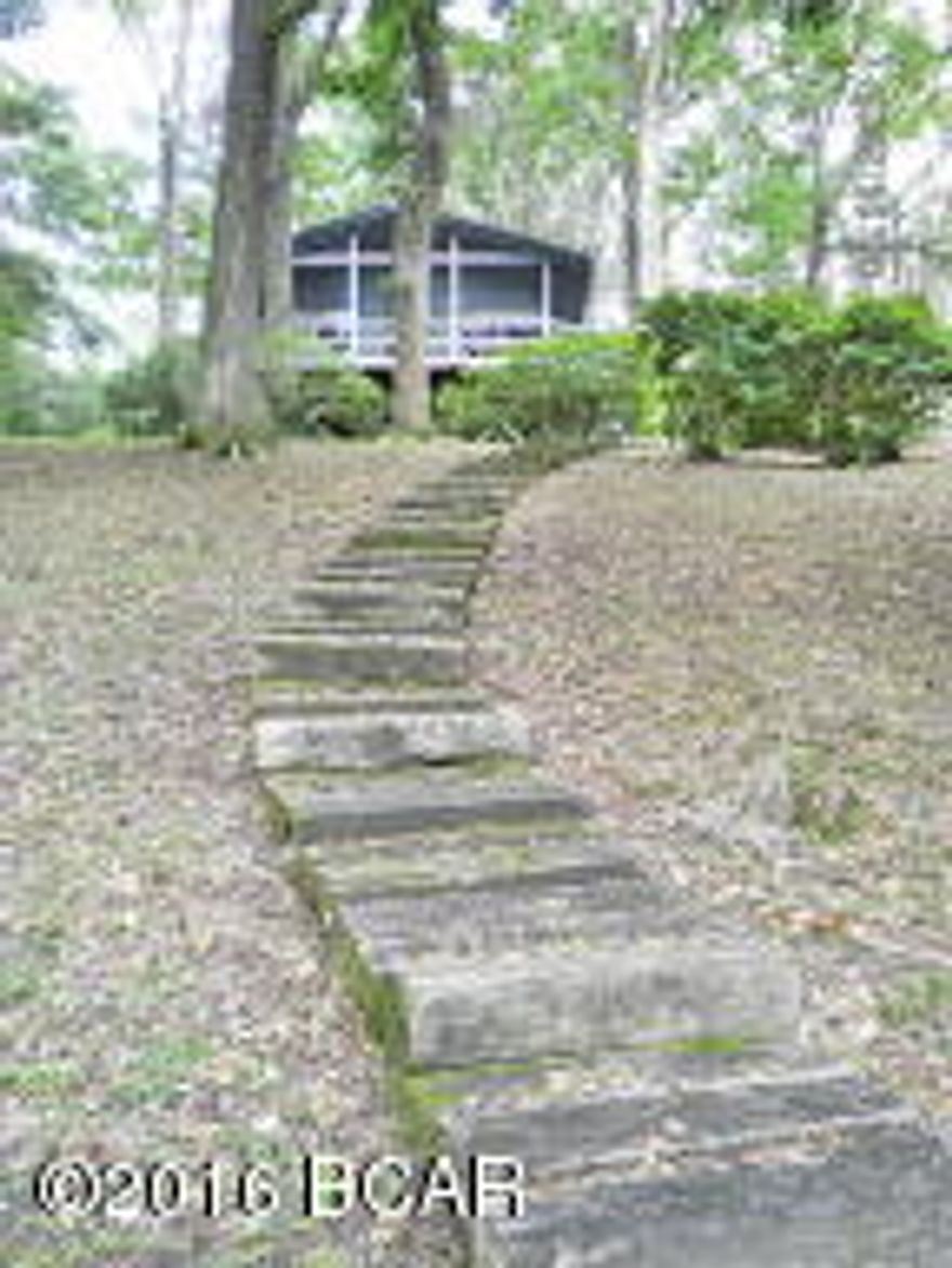 WATERFRONT !!! SELLER HAS AGREED TO DO OWNER FINANCING, CALL AGENT FOR DETAILS. Own your private get-a-way spot on beautiful Ocheesee pond,a 2200 acre lake that is full of bass, brim,and crappie. This cottage is just perfect for a retirement home or a place to vacation boating and fishing. It has a covered boat dock to keep the boat dry. The wood walkway leads up to the cottage.All on a dirt road for peace and quiet, but just a few blocks off a paved road. This little area is well know for a fishing community. Bring your boat and enjoy the quiet life. New power line and breaker box installed in April 2014