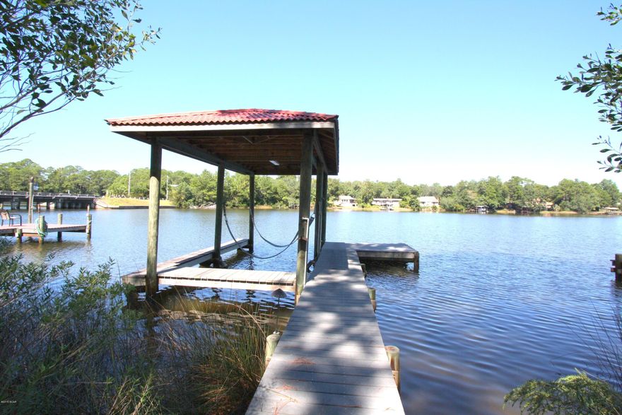 Waterfront living at it's best! Imagine yourself on the deck with a morning cup of coffee at the sunrises. Do you have a boat? If not, get one! This wonderful townhome right on Callaway Bayou has boat dock and boat house that can hold an 18 ft boat. Boat house even has tile roof to match home. This newly painted inside and out HomePath property features Great room with wood beams, unique lighting and soaring ceilings, and bay window for more open feeling and light from the awesome water views, stainless steel appliances and refinished cabinet doors in the kitchen, brand new carpet everywhere where there is carpet, both bathroom tubs and surroundings were re-glazed! Home has an oversized one car garage, hurricane shutters on main windows, fully fenced backyard. These are spacious units for easy living on the water and won't last long. Call your Realtor today! Age, Square Footage, and room sizes approx., if important please verify.