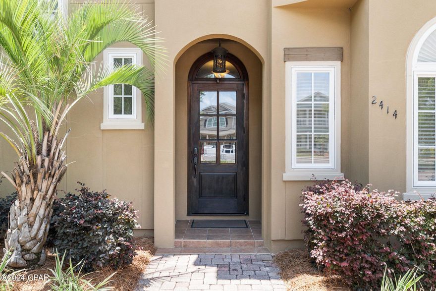 CURRENTLY UNDER CONTRACT, SELLER WILL CONSIDER BACKUP OFFERS An inviting custom built home by John Willis Homes is nestled within the esteemed gated bayfront community of Magnolia Bay Club. This charming 4-bedroom home exudes Tuscan-inspired elegance, offering 1,812 square feet of comfortable living space, a 2-car garage, and upscale finishes throughout, including travertine tile, crown moulding, a paver driveway, and more. A new tile roof was installed in 2019,  a new HVAC in 2019, and as a bonus the home is offered furnished. 

Convenience meets luxury with this prime location, providing easy access to shopping, dining, the pristine white sandy beaches, and a plethora of community activities. Step inside to discover the heart of the home - an open gourmet kitchen adorned with custom cabinetry, granite countertops, and Frigidaire Gallery Series stainless appliances, including a gas stove and wine cooler. The breakfast bar invites casual dining and effortless entertaining.

The home boasts two master suites, providing flexibility and privacy for residents and guests alike. The first-floor master offers convenience, while the second-floor retreat promises elevated views and tranquility. The master bathroom is a true oasis, featuring dual vanities, a tiled walk-in shower, and a luxurious soaking tub - perfect for unwinding after a long day.

The dining area seamlessly flows onto the covered back porch, creating an ideal space for outdoor gatherings and al fresco dining. Additional bedrooms ensure ample accommodation options for family and visitors, while the gated community offers a wealth of amenities to enhance your lifestyle.

Indulge in the resort-style amenities, including a bayfront swimming pool, dining pavilion, gas grills, clubhouse with a fitness center, TV lounge, and billiards/ping pong. Children will enjoy the playground, while outdoor enthusiasts can explore the community dock and private beach with complimentary kayaks for owners.

Experience the epitome of coastal living at 2414 Grandiflora Boulevard - where luxury meets convenience in a vibrant waterfront community. Don't miss your chance to make this idyllic retreat your own. Schedule a private tour today!