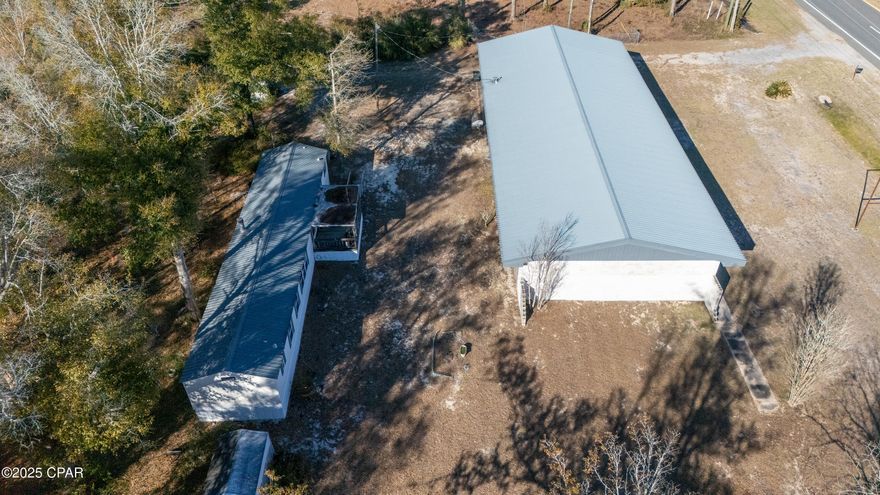 Great commercial property located on Hwy 231 in Fountain area of Bay County with 258 front feet on Hwy231 and 309ft deep. It has a 4558sqft shop with inside storage. The 4558 building could also be used as a commercial  warehouse with a double bay garage. The property also includes a 1216 sqft, 3 bed, 3 bath single wide mobile home behind the 4558 sqft building.  Endless business possibilities on approx 2 acres of commercial C-3 zoned land. The address of the warehouse is actually 17139 Hwy 231, however it sits in front of the mobile home which has an address of 17135 Hwy 231. Property has water well with water treatment system and two septic tanks. Metal roofs on warehouse and mobile home. HVAC in mobile home less than a year old. Only the mobile home is air conditioned. The warehouse building has a propane tank for heat. Buyer to verify all information.