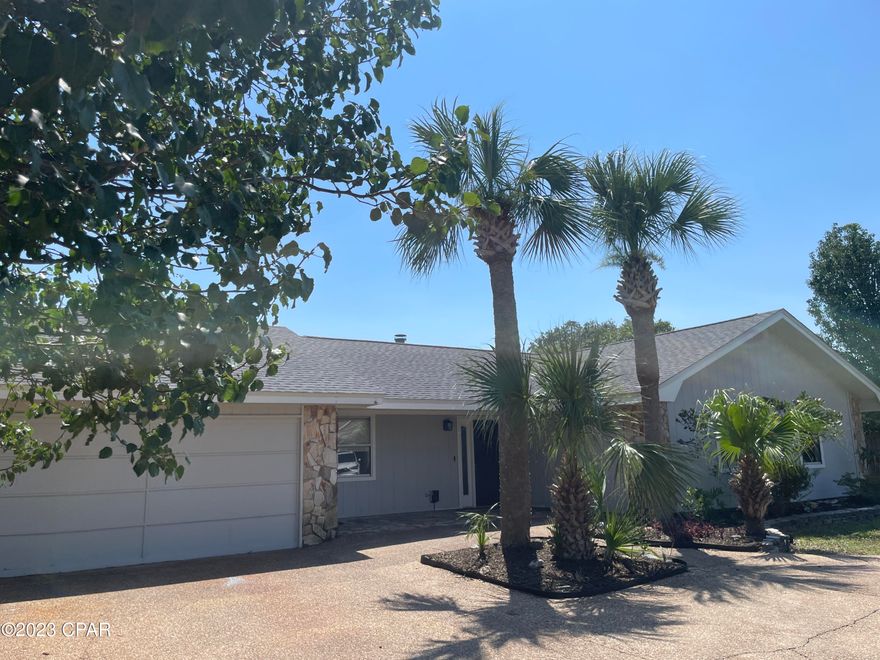 Quiet cul-de-sac location with NO HOA! and SHORT-TERM RENTALS ALLOWED!  Over one-third acre, plenty of room for boat parking with privacy-fenced backyard and covered patio!  This 3BR/2BA offers  5 year-old roof, updated kitchen and baths plus 400 sq. ft. bonus room...perfect for craft room, man cave or indoor she shed!  Kitchen offers granite countertops, stainless appliances.  New vinyl plank flooring in living area plus wood-burning fireplace for cozy winter nights!  5 minutes to Grand Lagoon and the beach!  Owner has termite bond too!
