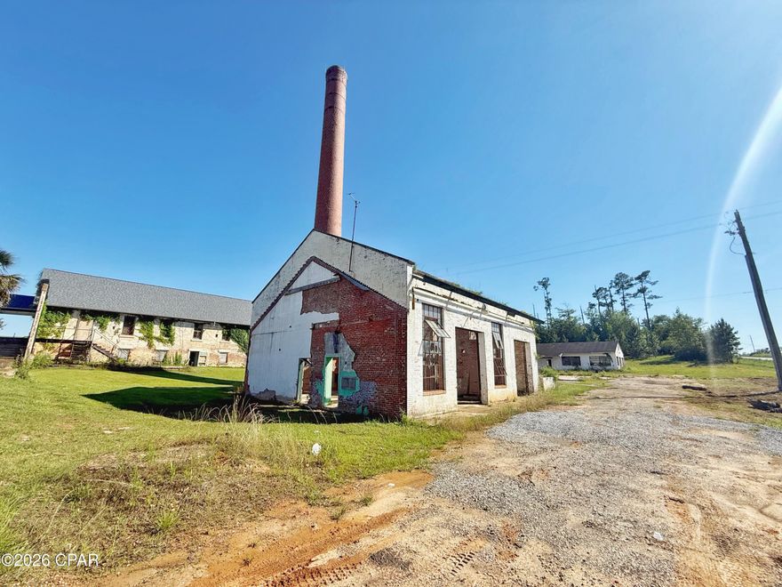 Positioned within the newly formed Endeavor Park, this historic Smokestack building offers a rare opportunity for visionaries, investors, and entrepreneurs to become part of the revitalization of one of Marianna's most transformational redevelopment areas. Situated inside the expansive 1,200-acre park, this property is ready for renovation, restoration, and imagination to bring new life back into a once-prominent structure.
Surrounded by momentum and progress, the area is already seeing significant investment and redevelopment with neighboring projects including the newly opened Jackson County Civic Center directly across the street, as well as the growing campuses of Chrome Ministries and Next Steps. The vision for Endeavor Park centers around renewing and repurposing a historic area of Jackson County into a thriving destination for business, community, and opportunity.
Bring your business concept, creative vision, or redevelopment plans and help shape the future of Jackson County by revitalizing the original Smokestack building into something remarkable once again. Commercial zoning and city utilities available for hookup.