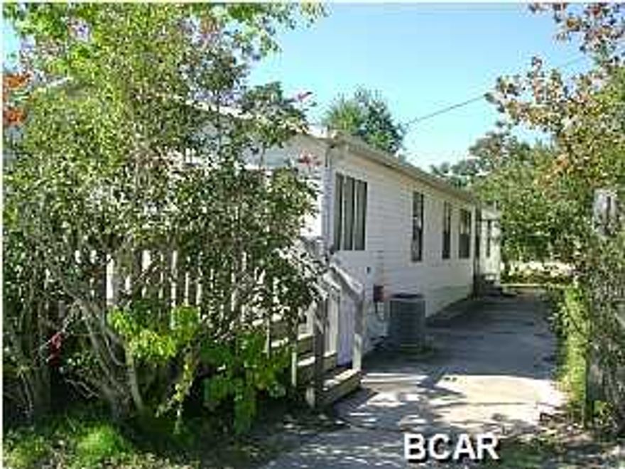 Double wide home with large decks on nice lot, eat in kitchen and separate dining room, split bedroom plan, washer and dryer connections, storage building. Walking distance to the beach.