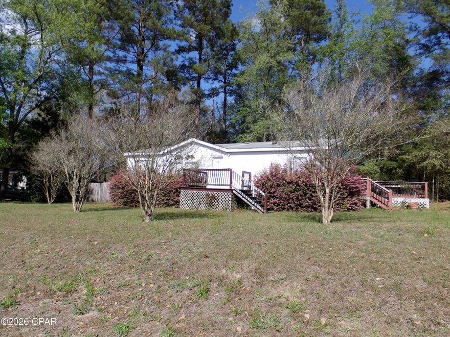 Three bedroom two bathroom manufactured home with carport and 10x14  shed offered as is.  The home a deck on the side, a master bedroom walk in shower.  The home sits on a larger triangular lot.