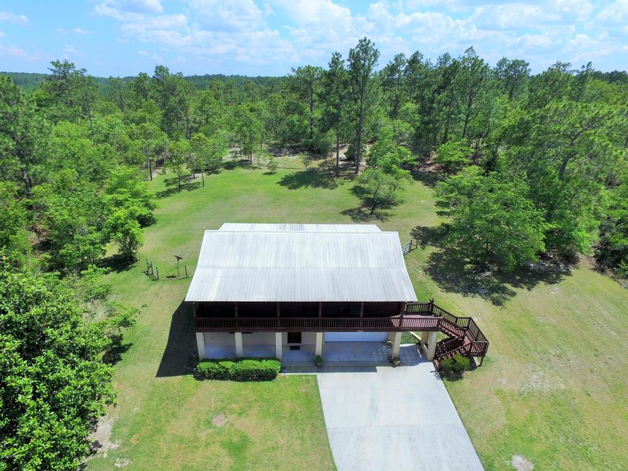 Enjoy country living and the amenities  of Compass Lake in the Hills. This beautiful 3/2 log home is finished with tongue and grove pine throughout the main living area.  AC/HEAT unit was replaced within the past five years, comes underground electric and phone line and also incudes generator in case of power outage, commercial grade sprinkler system, ADT alarm system, come with a Termite Guarantee, metal roof was put on in 2003 and has a warranty on it.  Home has a oversized two car garage that has a built in workbench.  All furnishing at the home will convey with purchase.