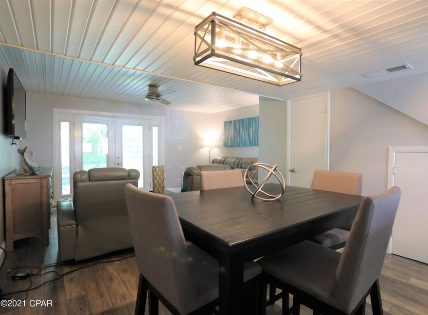 IMMACULATE, PERFECTION, CLASSY & BEACHY are just a few words that have been used to describe this meticously kept condo! Everything was replaced in this condo, EVERYTHING!! Ceilings, floors, ALL appliances, ALL furnishings, ALL countertops are quartz, even upgraded all 3 toilets!! Stainless Steel farm sink and appliances are 1 year old. HVAC was replaced in 2016 and water heater was replaced in 2015. There is NOTHING else to spend money on! With a covered carport at this condo, parking is NEVER an issue, also perfect for your golf cart to stay out of the elements! The top deck from the bedroom upstairs in great for entertaining and relaxing! This condo actually has a quite BACKYARD for playing with kids and pets while grilling on the very nice back patio! DO NOT MISS THIS!!