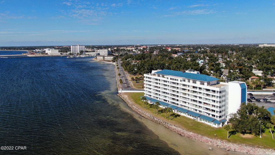 WATERFRONT CONDO ON ST ANDREW BAY! You can't beat the views from this 2BR/2BA at Cove Condominium. Relax on the broad balcony and watch the dolphins swim by. The living room, dining room, kitchen & master BR all offer spectacular views of St. Andrew Bay. The kitchen features stainless Whirlpool appliances, a pantry & breakfast bar connecting it to the dining and living room. New carpet in the bedrooms, otherwise, tile throughout. Vertical blinds have been installed on all windows. The master BR has floor to ceiling windows w/ sliding door access to the balcony, a large walk-in closet and a master bath w/ walk-in shower. The 2nd BR has it's own full bath. A stackable washer and dryer is included. In addition to the two storage closets in the entryway, there is a detached storage room at the end of the walkway on the 5th floor designated for unit 503. Community amenities include a pool overlooking the bay, clubhouse, dock, and pet area. Swim, boat, paddle board, take advantage of fantastic fishing or enjoy a short walk down the sidewalks of E Beach Dr to all the shops and restaurants in historic downtown Panama City. This unit is clean and move-in ready or upgrade it to your own personal paradise. All sizes, measurements and dimensions are approximate and should be verified if important.