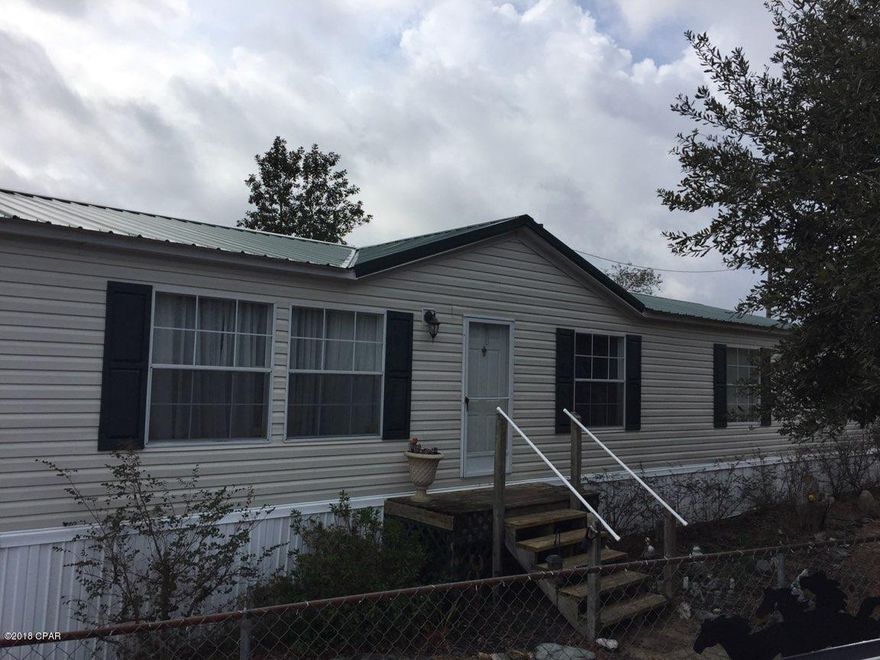 Located just off Hwy 77, in the Greenhead area. Beautiful, 2280 sf, 4/2 home on 5.2 acres- If you are looking for somewhere to have horses or a mini-farm/garden. Just think, no more loading up the horses to go for a ride. Lots of marked trails located right behind your home to enjoy riding in the adjoining NWFL Mgt area. Land comes with a 3 stall barn with attached tack/hay room, 3 paddocks, outside lighting, water, 24x20 detached shed, 10x12 shed, bonus detached workshop with carport.  Home has fireplace, split bedroom plan, and a huge 15x30 den with wet bar for multi uses. Spacious kitchen, loads of cabinets, built in separate oven, pantry, dining room and so much more. Circular driveway. Majority of property is fenced. Chain link fenced front and  backyard for pets.  Circular driveway. Several outbuildings., included is a 20x20 open pole barn, 24x20 metal shed, 10x12 metal shed, plus the barn and stalls. So much morre.  Call me or your realtor for a private showing today