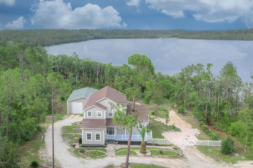 CURRENTLY UNDER CONTRACT, SELLER ACCEPTING BACKUP OFFERS

Stunning two-story with the best views of McCormick Lake, remodeled in 2019. The circular driveway takes you down to this large home sitting on three lots totaling almost 3.5 acres with a pond, 50'x35' garage, and another metal outbuilding. The wood-look tile plank throughout the first level adds a beautiful accent and is long lasting. The new kitchen features custom cabinets, stainless appliances, and quartz countertops. It is open to the dining room which is open to the living room. Great for entertaining! Both rooms have French doors overlooking the lake. Enjoy lake views from your hot tub in the incredible glassed-in Florida room that overlooks the back yard, lake, and pond. This room features LVP. The master bedroom, on the fir doors. Within the master is a huge walk-in-closet and spacious master bathroom. There is an additional bedroom, bathroom, and the laundry room on the first floor. Upstairs there are three more bedrooms and a bathroom. At the top of the stairs there is an open area that would serve well as a sitting or play area. The second level flooring is LVP and the bathroom is tile. The exterior of the home features long lasting Hardie-board siding. This home is perfect for a large family or anyone who loves the lake life. Compass Lake in the Hills is a 10,000-acre property with two pristine lakes that has a lot to offer. McCormick Lake is an exclusive facility only available to members and their guests. At McCormick Lake there are canoes, fun yaks, and a beautiful beach on a serene lake. There is a lodge and two covered pavilions also available for rental. Fishing boats with electric motors are allowed and offered for rental. The lake is pristine due to the fact that they do not allow gas motors on the lake.