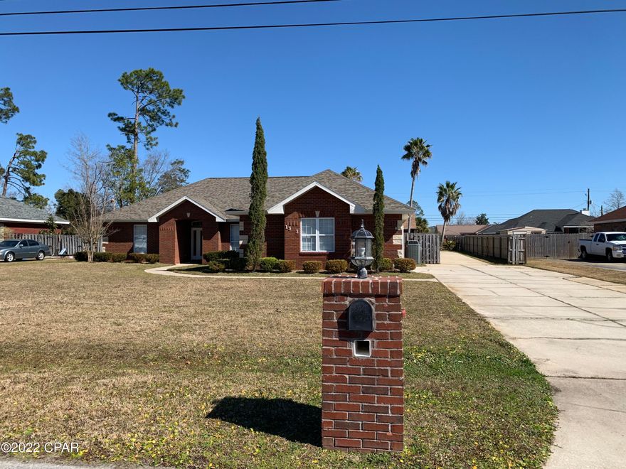Custom brick home in popular Lynn Haven.  This beautiful home has all the extras that you want in a home but can't seem to find elsewhere.  Home sits on a large 100x150 lot.  There is plenty of parking for your boat, RV or trailer.  The 20x30 detached garage/workshop has a roll up door and a half bath.  This is a must for the hobby enthusiast, custom car storage, home gym, mechanic, or much needed storage space.  The home features separate living areas such as a formal living room, family room and Florida room.  The large open kitchen features lots of cabinets and quartz countertops.  The open kitchen along with the family room with built-in surround sound is perfect for entertaining. The very spacious master bedroom will hold the largest of king size bedroom furniture and features a... walk-in closet, custom bathroom and screened-in patio.  The master bathroom features a double vanity, tub and large custom tile shower.  There are two additional bedrooms downstairs and a forth bedroom/bonus room on the second floor.  The Seller is offering a carpet allowance with acceptable offer.