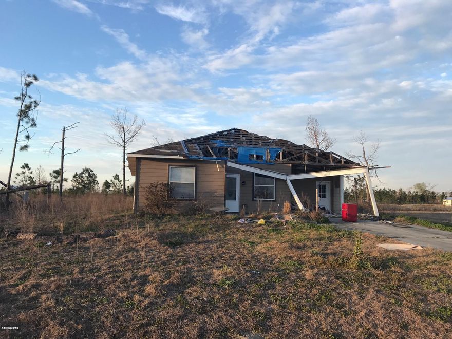 Hurricane damaged home being sold as.  The roof on the front section of the home blew off during the hurricane.  Home needs extensive repairs.  It was a beautiful 4/2 home with trey ceilings and granite countertops (could be saved).  Tankless water heater installed just before the storm.  Come bring this home back to life!!