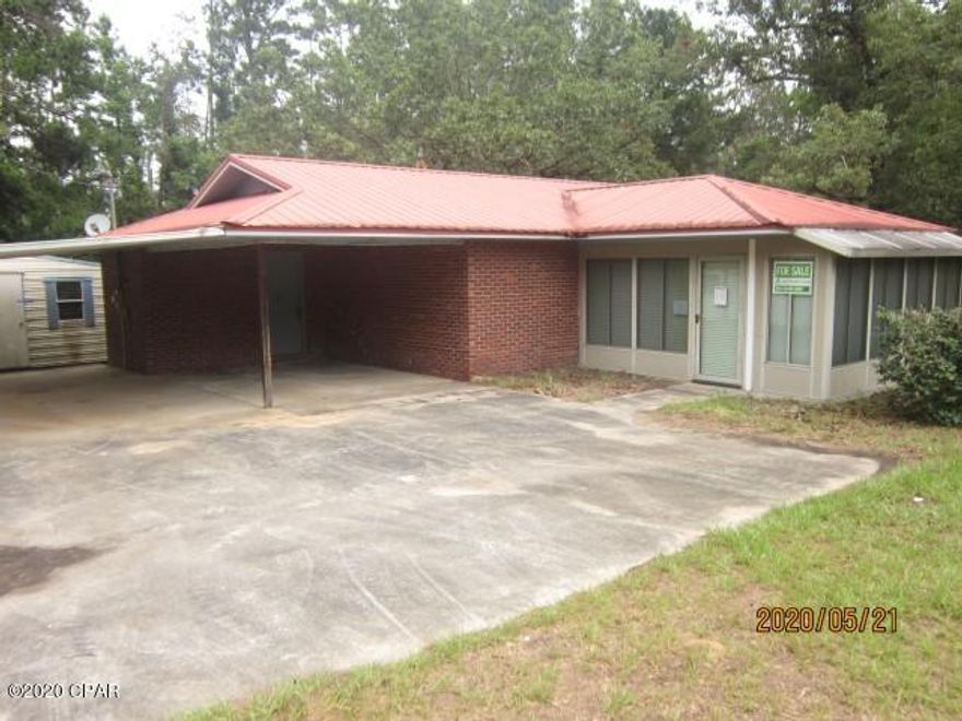 Slightly over 1 acre lot enclosed by chainlink fence (fence damaged by hurricane and not repaired).  Home is brick construction with metal roof, two bedrooms, one bath (County record shows 2 baths, not correct).  Living, dining and kitchen is open concept, front sunporch is finished,  kitchen with breakfast bar and small dining area not including the Living/Dining room.  Much of interior walls and ceilings have been stripped out due to mold problem (vacant for long time).  FreddieMac First Look Initiative applies to this property until June 29,2020.  Owner occupants and some non-profits agencies have a chance to offer without competition from investors.  Investor offers prior to that date will be held and if no owner occupant offers are accepted will be submitted for consideration.