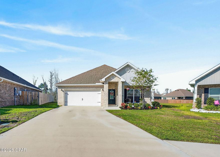 Welcome to this perfectly maintained and tastefully decorated 2022 all-brick home situated on a prime lot in the highly desirable Andrews Plantation community in Lynn Haven. This spacious 4-bedroom, 2-bath residence with a 2-car garage offers 1,835 sq ft of open-concept living, designed with both comfort and style in mind. 

Step inside to discover raised ceilings with 10-foot tray accents, elegant crown molding, and luxury vinyl plank flooring throughout the entire home--no carpet. The gourmet kitchen features stainless steel appliances, granite countertops, a modern subway tile backsplash, and a large center island with cabinetry on both sides, creating a perfect space for everyday living and entertaining. Natural light pours through energy-efficient windows, enhancing the home's inviting ambiance. The primary suite boasts a luxurious en-suite bath with a garden tub, a spacious walk-in shower with glass enclosure, and a double vanity. Enjoy your morning coffee or evening gatherings on the screened porch overlooking a serene backyard. The property backs up to wooded areas, providing additional privacy.

Additional features include gutters, an irrigation system utilizing reclaimed water, and a beautifully landscaped yard. Centrally located just minutes from top-rated schools, shopping, dining, boat ramps, parks, and more--this home offers the ideal combination of privacy, convenience, and modern living. The home is equipped with removable plywood hurricane shutters. Furniture is negotiable. Don't miss your chance to own this move-in-ready gem-schedule your private showing today!