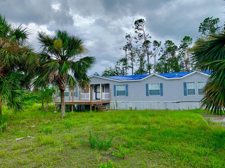 Very large 4 bedroom 2 bath mobile home on just over half an acre. When you enter the home, you are welcomed by the living room with fireplace and built in cabinetry. Next to the living area is the open dining area with more built in cabinets! The large open kitchen comes with lots of cabinets and a pantry, Island with sink and dishwasher built in, and there is even a bench seat under a full size window! This home has a split bedroom floor plan with the laundry room, spare bathroom and 3 bedrooms on one end. The laundry room has even more built in cabinets with counter top space! The master bedroom and bath are on the other end of the home with 2 walk in closets, a garden tub, separate shower and double vanities! Extra room off the living room with yet again, more built in cabinets! This space would be great for an office or workroom. Besides the large home, this property also comes with an even larger detached workshop/garage. Note: some repairs on detached oversized garage are needed. There are 3 garage door bays, extremely tall ceilings, built in shelves for storage and an area for an office. You must see this property to fully appreciate all it has to offer. This is a corner lot with vacant land to the right and directly across the street from the front door. Call today for an appointment to view this unique property with so much potential due to the large garage!  All measurements are approximate, buyer should verify if important.