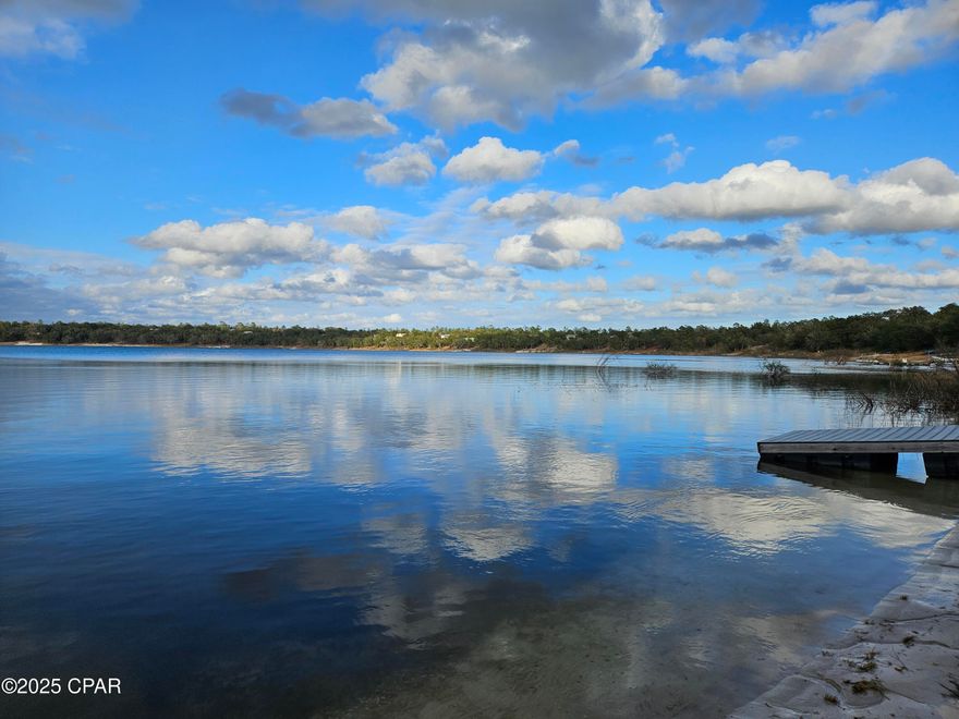 'CURRENTLY UNDER CONTRACT, SELLER WILL CONSIDER BACKUP OFFERS ' This is a wonderful waterfront lot in the security gated subdivision of Leisure Lakes, just off Hwy 77. Located about 30 minutes north of Panama City, this shaded lot by oak trees has with a gentle slope down to the crystal clear water. Located on the southeast side of the lake, this is a good location to see the beautiful sunsets that other residents enjoy in the evenings. The lot has been only partially cleared so the new owner can sculpt the lot depending on the dimensions of the proposed house and decking. Docks are allowed up to 30 feet long, according to the covenants. The recreation area provides plenty to do as the photos show. There is a security gate and live guards are on duty weekdays. HOA dues are $250 each year. Come enjoy lakefront living!