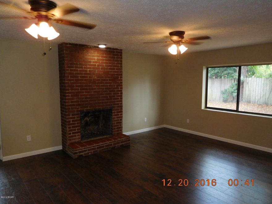 Newly renovated home with fresh exterior and interior paint as well as new flooring throughout, tile,Laminate wood floors and carpet. Kitchen has new cabinets and counter tops. Nice size bedrooms, formal livingroom as well as large family room with fireplace. Master bedroom has private bath and accesses the covered porch thru your double french doors. There is also a screened porch just off the family room overlooking the fenced back yard.