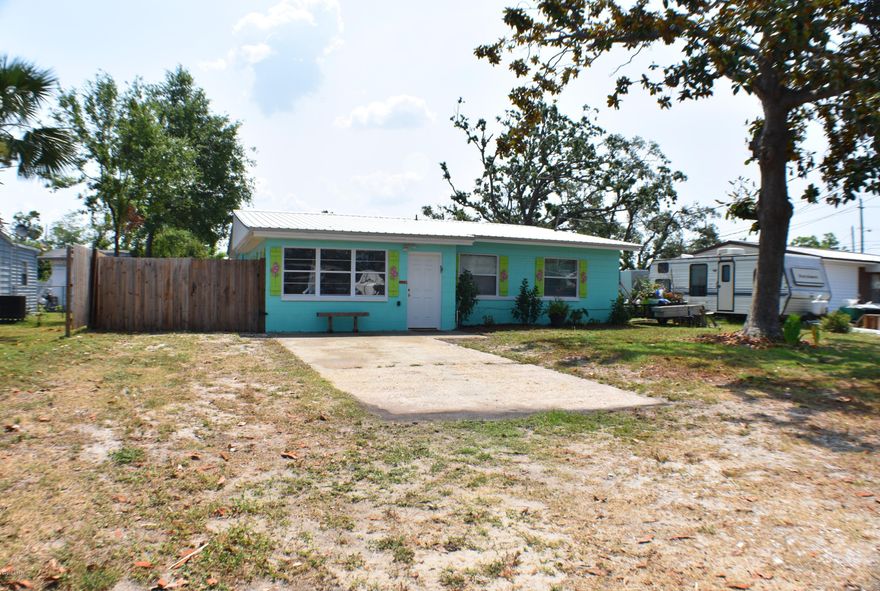 CURRENTLY UNDER CONTRACT, SELLER ACCEPTING BACKUP OFFERS.Charming and move-in ready 4BR/2BA home in the St. Andrews area near the colleges!  This home has been updated in recent years;  metal roof in 2017, wood look ceramic tile throughout home, new kitchen cabinets when they bought in 2015, new fixtures as well, & because this is a concrete block home... NO hurricane damage!  Interior features include built-in shelves, fireplace, extra storage & a bonus room. Off the back of the home is a large deck great for entertaining and there's even a hot tub that conveys!  The workshop with power is also a concrete block building!   The backyard is fenced & you could easily add a pool.  This is a great first-time buyer home & the location is nice & quiet! If you work at or attend Gulf Coast State College or FSU-PC, you'll be on campus in less than 5 minutes.  Shopping, the beaches, hospitals, etc... all convenient!  All info is approx. and must be verified by Buyers if important.