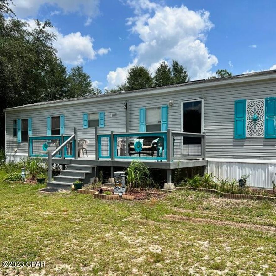 New roof December 2023!  1 acre home with a country feel and close access to hwy 231, hwy 20 and I-10.  Fully fenced property with lots of potential even includes a 30 amp hookup for a motor home or camper.  The interior of the home has been very well maintained with 2 bedrooms and 2 baths, large kitchen, dining area and inside laundry room. Light fixtures and ceiling fans have been replaced and are matching throughout.  Out the back door you will find a double carport with a concrete floor and a great private backyard.