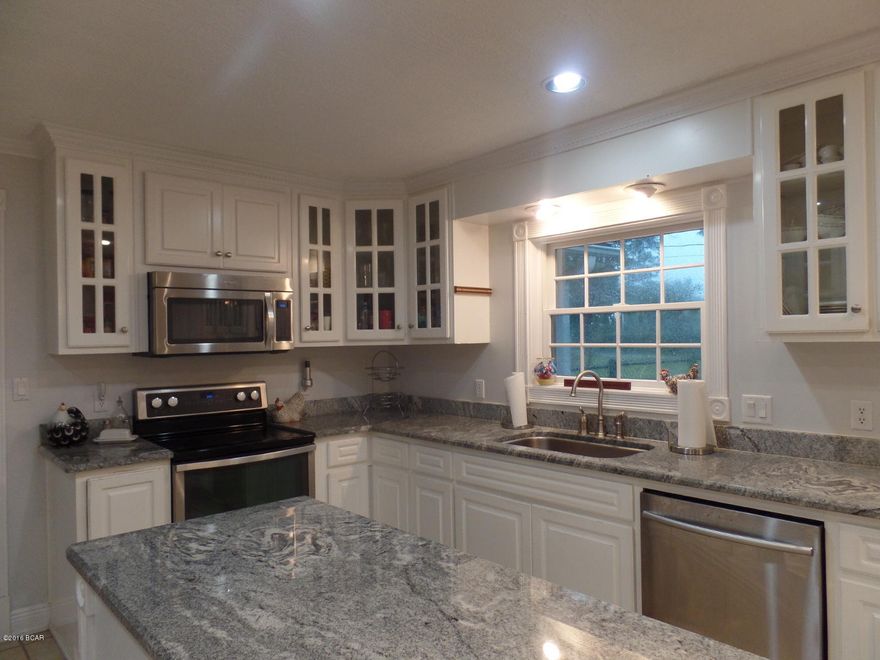 What a peaceful feeling you get the moment you step into this cozy, open, and spacious home on the canal (in the popular Northshore area of Lynn Haven.) If you have a love of boating, the dock has electrical and lift upgrades that will keep your boat high and dry. If you like to cook, you will fall in love with the new granite counter tops, additional lighting and new appliances in the kitchen and dining areas. Not only is the granite beautiful, there are cabinets galore and lots of counter space that includes a breakfast bar. The house is painted in soothing colors and the former recreation room (17 x 22) is now a 4th bedroom. The vaulted ceilings in the Sunroom and 4th BR are awesome! Most buyers want a fireplace, a garage, & a Master Bath with double vanities. Wishes Granted! Hurry!