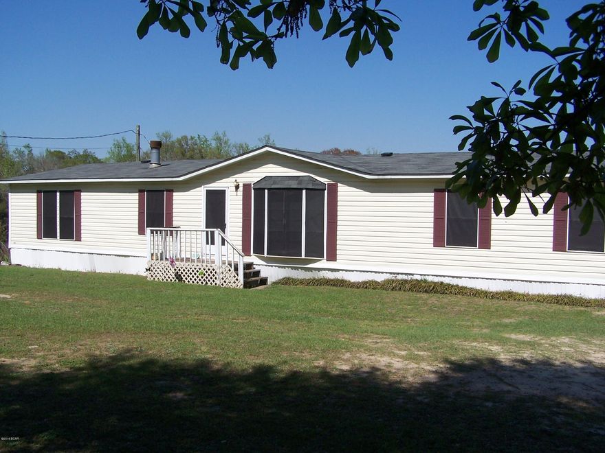 The Country Life starts here! Over 20acs of land with the majority of it cropland/pasture nestled neatly on the banks of a flowing Creek. The 3/2 Double Wide Mobile Home sits on the top of the hill and from one of grand porches you can see most of the land. The well maintained home has a New Roof (3/2016), split floor plan, Den with Fireplace and a ''big ole'' Family Kitchen! All of this is conveniently located just outside Graceville, FL so call today for your appointment.