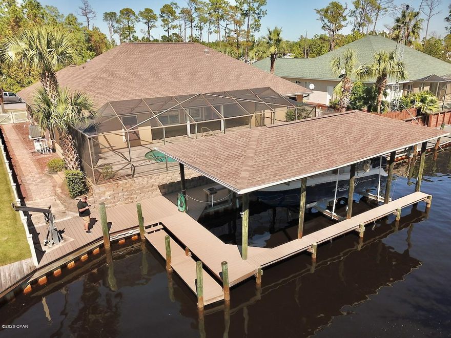 CURRENTLY UNDER CONTRACT, SELLER ACCEPTING BACKUP OFFERSThis Deep water, Gulf access, canal front home is a Boater's dream. This type of water front is rarely on the market!! This Home is located in the exclusive and gated waterfront community of Dolphin Bay. Dolphin Bay is known for it's private marina, boat launch and slips, lighted tennis courts and basketball court. Not only is the community a class act, the home has wonderful features such as  natural light, open floor plan , formal dining area, new roof, security system and hurricane shutters. The living and kitchen area open to the large salt water, gunite  pool area, oversized trex deck (10x96), large covered boatlift which can  accommodate 2 large boats and a small boat lift for your jet skis or Bay boat