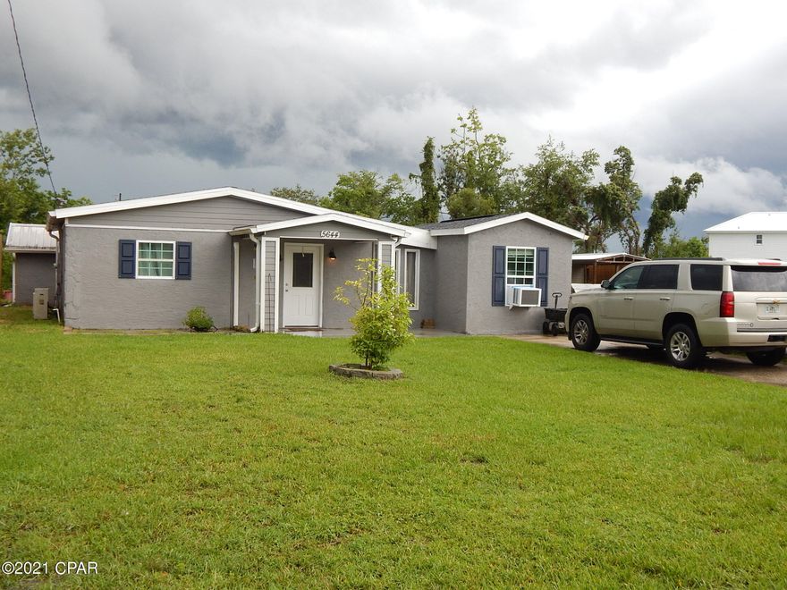 A rare find in the Callaway area under $200,000, with home  sitting on 1/2 acre.  If you are looking for privacy and seclusion.....this charming cottage  sits on a dead end cul de sac., and only  one block from Tyndall Parkway and walking distance to Super Walmart.  Mexico and Panama City Beaches are only 20 minutes away East or West.  Home was updated in 2014 with new kitchen cabinets, stainless steel appliances and granite counters.  New flooring throughout. Home is a 2 bedroom and 1.5 bath.  Washer and drier hookup.  Great parcel at 1/2 acre with room to add on a mobile home or another cottage etc.  Fully fenced in with large custom workshop in rear and two more additional sheds.  Home sits on a pond with dock and abundant with fish.  No flood insurance required and well water on hand If you are a small business owner,  you have plenty of land for parking and a large workshop shed.  New roof installed in 2019.  City water and sewer.  Enjoy the cool evenings sitting in your screened in back patio fully enclosed.  Make an offer as it will not last long.