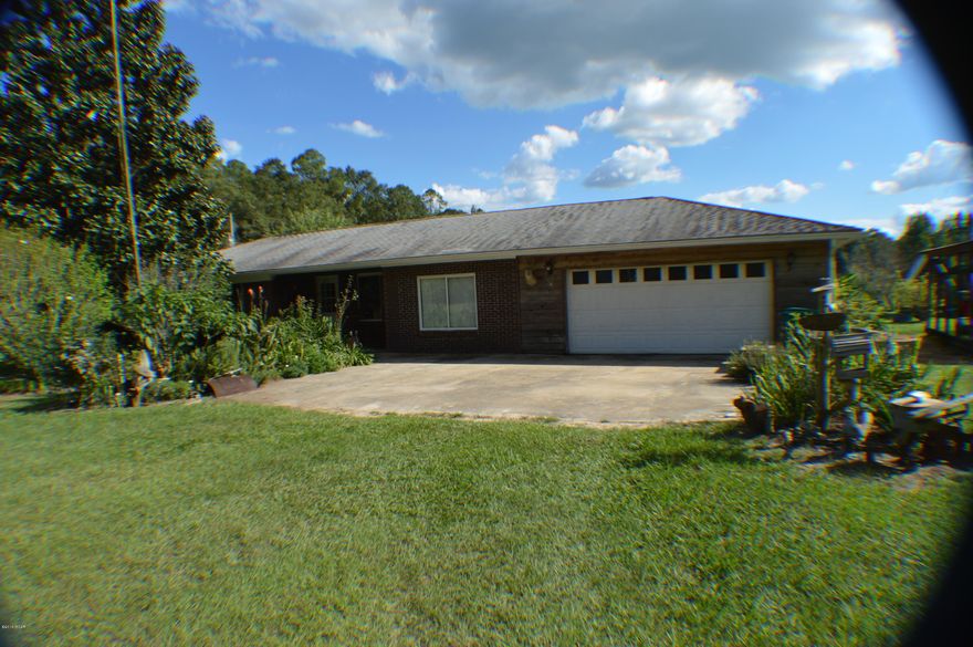 Private & secluded mini-farm on 10 acres conveniently located to town.  This rare find includes fruit trees, a vineyard with 3 different types of grapes, flower gardens, herb gardens, catawba worm trees and much more. A gunite in-ground pool with an in-ground hot tub are surrounded by a white picket fence.  There is a fully stocked pond with catfish, bluegill, bass and brim on the rear of the property.  There are several outbuildings to include a shop building, portable metal building, feed barn, 2 portable sheds, a pool shed, a greenhouse, and a 6 ft tall 100 x 60 chain link pen and a 2 car garage.  Carport has been enclosed to make a living room.   Hardwood and linoleum flooring throughout house.  Bedrooms need carpeting replaced. New cabinets, air conditioner and roof replaced in 2009.