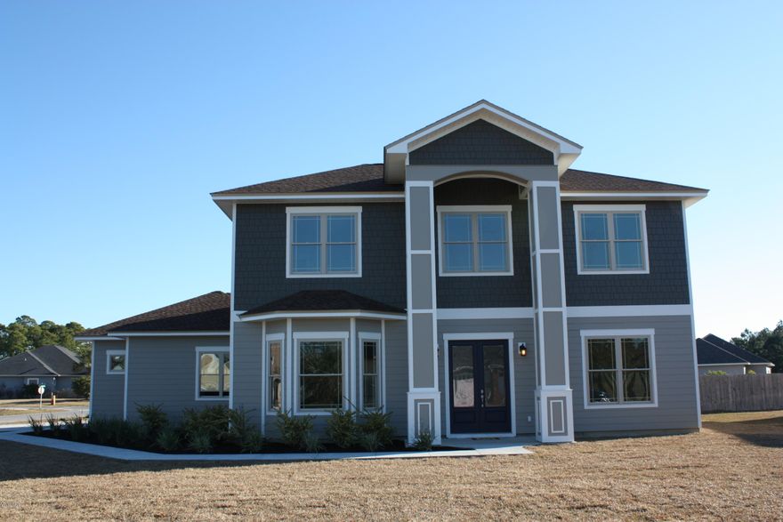 Another quality built, New Construction home in North Colony Club Estates. Golf Course/Water front community. This beautiful open/split plan has 2,363 suare ft, with four bedrooms, three full baths and one half bath. This partial two story home has an open plan with Master bedroom located on the first floor. The second story has two full baths and three large bedrooms. The well equipped kitchen features a large breakfast bar with pendant lights, 42''wood cabinets, stainless appliances and walk-in pantry. There is also a spacious dining area. The luxurious master bath boasts a large walk-in closet, a double vanity with brushed nickle faucets, granite counter tops, garden tub,and an over sized tiled shower. Some of the numerous interior features are, 10 ft ceilings, recessed lighting,crown molding, in common areas, 20" tile and granite in kitchen and all bathrooms. Exterior features consist of a fully sodded and landscaped yard, with automatic irrigation system ,and an extra large 613 ft garage, with 8ft tall garage door. Colony Club is centrally located to the beach, Pier Park and schools. Walk jog or ride your bike down Gails Trails for miles of paved nature trails, and golf on Holiday Golf Course. Agent is related to seller.