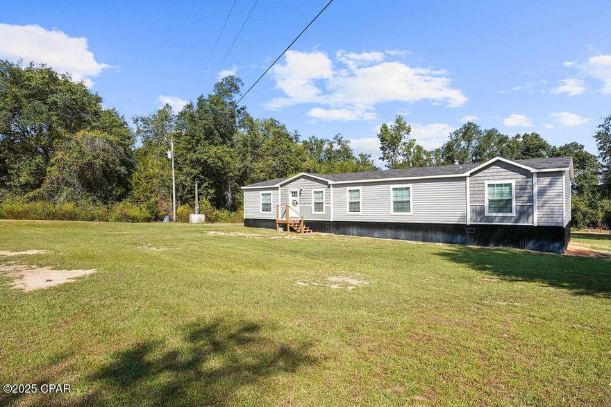 Welcome to this spacious 4-bedroom, 3-bathroom newer mobile home, conveniently located just off Highway 231 on Shores Road, across the street from Round Lake, with quick access to Panama City. Designed with an open-concept layout, the home features a cozy electric fireplace insert in the living area, creating a warm and inviting atmosphere. The kitchen is well-appointed with stainless steel appliances, a large island, and ample cabinet space—perfect for both everyday living and entertaining.

The master suite offers a relaxing retreat with double sinks, a soaking tub, and a beautiful tile shower. Two of the additional bedrooms share a convenient Jack-and-Jill bathroom, while the fourth bedroom enjoys access to another full bath. A versatile den provides extra space for a home office, playroom, or second living area.

With modern finishes, a thoughtful floor plan, and its prime location across from Round Lake, this home combines comfort and functionality in a setting you'll love. Don't miss your chance to make it yours!
The master suite offers a relaxing retreat with double sinks, a soaking tub, and a nice sized shower. Two of the additional bedrooms share a convenient Jack-and-Jill bathroom, while the fourth bedroom enjoys access to another full bath. A versatile den provides extra space for a home office, playroom, or second living area.

With modern finishes and a thoughtful floor plan, this home combines comfort and functionality in a prime location. Don't miss your chance to make it yours!