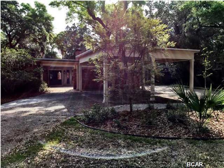 Owner say Bring Offers!! This newly remodeled, professionally landscaped 3,100 square foot home has 4 bedrooms, 3 bathrooms, living room, kitchen, dining room, family room, laundry room and storage room/office. Property also features an outdoor detached storage facility with covered parking that is accessible from rear alley. The home is situated across the street from St. Andrew's Bay, with sunset views from the courtyard situated at the entrance to the home. Amenities of the home include a large wood burning fireplace, large cedar wrapped ceiling beams, hardwood floors in the main living spaces, natural stone in the entrance and kitchen, wall to wall wool carpeting in the bedrooms, statuary marble in the master bathroom, large walk in shower and soaking tub in the master bath.