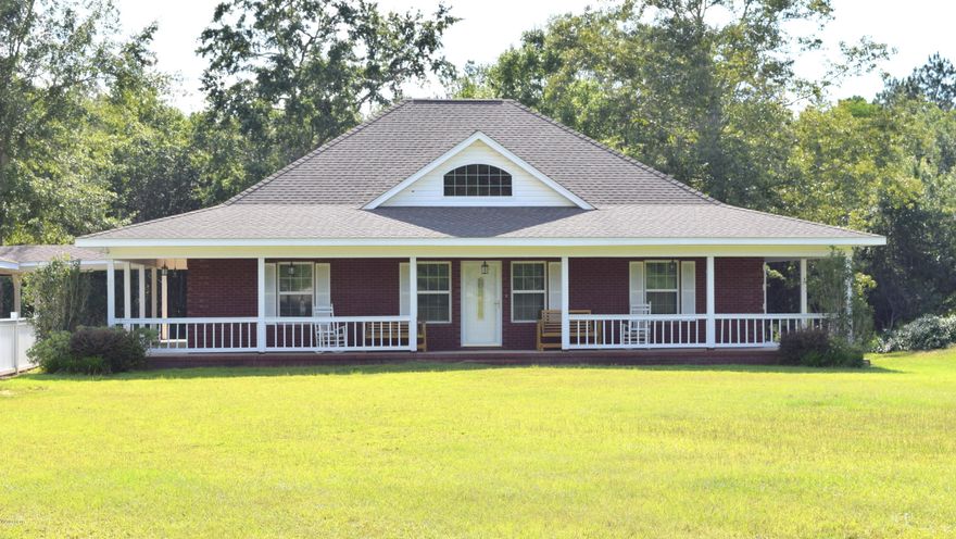 Secluded down a private drive and nestled on more than 12.4 acres sits this country style brick beauty. Enter inside and you will find an open eat-in kitchen with breakfast bar, custom cabinets, large pantry and stainless steel appliances. The master suite features an oversized walk-in closet, double vanity, custom tile shower with double shower heads, niche, bench seat and a new frosted sliding glass door. Outside you will find a partial wrap around porch, 15x35 gunite pool equipped with jets, heater and concrete decking, 24x36 carport with breezeway, detached shop and fish pond stocked with bream, catfish and bass. Home is located 0.2 miles off Hwy 90 close to schools and dining.