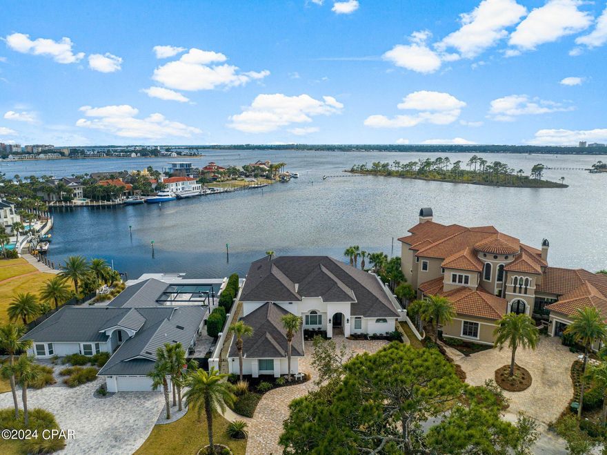CURRENTLY UNDER CONTRACT, SELLER WILL CONSIDER BACKUP OFFERS' Waterfront gem in gated Bay Point neighborhood, boasting 90 feet of deep water frontage east of the bridge. It has ample space for a large yacht and convenient Gulf of Mexico access. Recent $100,000+ upgrades include marble kitchen, rich hardwood flooring, and fresh interior/exterior paint.

The covered patio offers stunning Grand Lagoon views, a pool, and hot tub. Wildlife sightings of deer, fish, and dolphins are common.  Three car garage equipped with an electric vehicle charging station and has plenty of room for your golf cart.

The master suite on the first floor features patio access, a spa-like bathroom, and a spacious closet with a dedicated hot water heater. The open kitchen, office, living room, and family room all enjoy  waterfront views and high ceilings.

Bay Point offers 24 hour security, a Nicklaus Championship Golf Course and is home to the new Point South Marina.  Don't miss the chance to make this exceptional waterfront property your forever home.    Welcome to waterfront luxury! This waterfront property is situated within the secure gated community of Bay Point. With 90 feet of deep water frontage, it offers ample space for a large yacht and provides easy access to the Gulf of Mexico.

Recently, the house has seen significant upgrades, with over $100,000 invested in improvements, including a new kitchen with marble features, hardwood floors throughout, and fresh interior and exterior painting.

The covered patio boasts stunning views overlooking the Grand Lagoon, and you'll find a pool and hot tub for your enjoyment.

The master bedroom suite, conveniently located on the first floor, provides direct access to the patio. It features a spa-like bathroom, a spacious closet, and its own hot water heater.

The large open kitchen, office, living room, and family room all offer incredible water views and feature high ceilings, creating a spacious and inviting atmosphere. Don't miss out on this fantastic waterfront home in Bay Point!