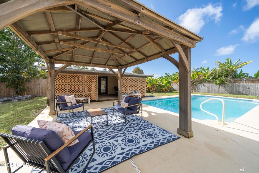 Searching for the perfect Christmas gift? This ranch style pool home just might be what your family is dreaming of.
Add this charming 3 bedroom 2 bath home with in-ground pool, pergola & workshop to your gift list. It offers a spacious living room with a cathedral ceiling and a functional layout ready for entertaining or relaxing with family. Outdoors, enjoy your own private oasis featuring an in-ground swimming pool and a pergola-covered patio that provides ample space for gatherings or quiet evenings under the stars. The property also includes a detached shop with electricity, perfect for a pool house, hobbies, storage, or a home workshop. The possibilities are endless. A corner lot property offering the perfect blend of comfort and convenience, located just minutes from shopping, restaurants, and local amenities. This home combines peaceful living with easy access to everything you need.
 *Roof 2025 *Windows 2024 *HVAC 2022 *Water heater 2024 *Pool pump 2022 *Pool resurfacing 2021 * Electrical Panel 2022 *Only minutes to shopping and restaurants on 23rd St *15 min to Navy base *8 minutes to Gulf Coast State College *5 min to Pretty Bayou Boat Ramp

Call today to schedule a viewing appointment and you could be moved in before Christmas.