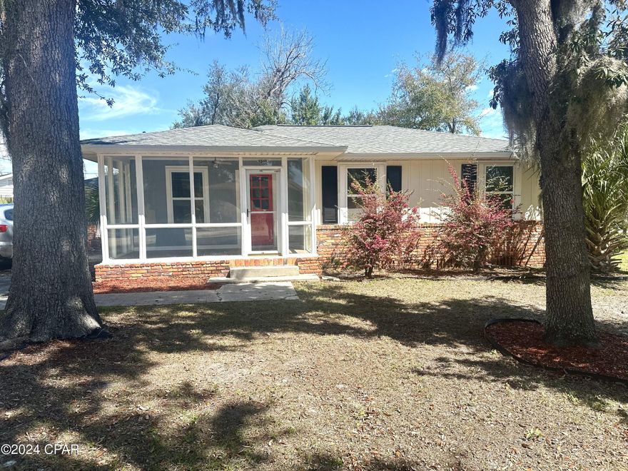 CURRENTLY UNDER CONTRACT, SELLER WILL CONSIDER BACK UP OFFERS Come check out this Cozy Cove home! Beautiful corner lot with tons of coastal greenery including rose bushes. Enjoy the scenery on the enclosed front porch. Close to all of Down Town dining and shopping. Home has original hardwood floors in living room, dining room and 3 bedrooms.There are two additional rooms that were added to the property that have not been added to the base square footage. This includes a mother-in-law suite, Florida room and  a second bathroom. Roof, windows, and AC were replaced in 2018. Waiting on a projected finish date on repaving road.