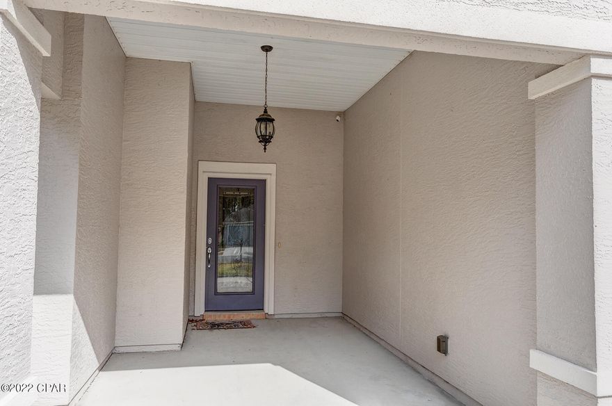 As you pull into the driveway of this pristine home, you are welcomed by the garden beds with large Florida palms. Entering the front door through the foyer of this split floor plan home, you notice the large living room finished with a cathedral ceiling and wood like tile flooring, that leads you into the kitchen with a breakfast nook for hosting Sunday morning brunch. The gorgeous granite countertops add an elevated touch along with the stainless appliances, refrigerator conveys with sale. The best part about this corner lot is the oversized amount of space to accommodate any and all activities. Amenities includes two community pools and is in close proximity to Pier Park and the beach.  Call for a personal tour, this home will not last! New roof 2019,A/C 2018, water heater replaced also