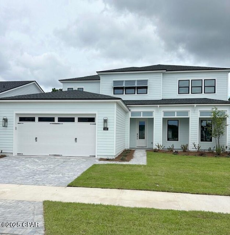 This stunning two-story residence boasts over 3,000 sq ft of beautifully designed living space, featuring 4 spacious bedrooms, 3.5 luxurious bathrooms, versatile study/office—perfect for working from home or flex space, upstairs enjoy a spacious bonus room—ideal for a game room, media room, or additional lounge area, and 3-car large tandem garage providing extra length for an oversized vehicle or spacious storage. 

Step inside the two story foyer with 20' high ceilings, styled with beautiful open railing. Luxury vinyl plank flooring throughout with elegant tile in all bathrooms. The gourmet kitchen has upgraded cabinetry, quartz countertops, a stylish tile backsplash, and stainless steel Kitchen Aid appliances. The open-concept layout flows seamlessly into the great room and dining area, making it ideal for both everyday living and entertaining.

The private first-floor bedroom with its own full bathroom is perfect for guests or multi-generational living. 

Retreat to the luxurious primary suite featuring a tray ceiling, two closets, and a spa-inspired bathroom with duel vanity with quartz and a frameless glass tile walk-in shower.

Outdoor living features a paver driveway with a walkway to covered front porch, multi-slide stacked glass doors from great room to large covered paver lanai with views of peaceful woods—your own private sanctuary. Backyard has space to build your dream pool oasis. 

Located in a gated community offering resort-style amenities such as a sparkling pool, clubhouse, fitness center, pickleball & tennis courts, playground, multi-purpose field, and more—this home offers the perfect blend of luxury, privacy, and community.

Located just minutes to beautiful public beach access, Frank Brown Park, Northwest Florida Beaches International Airport, future FSU/TMH medical campus, future West Bay Center with Publix, Pier Park shopping, dining, and fun entertainment.

Don't miss this rare opportunity—schedule your private tour today! New construction available for quick move-in.