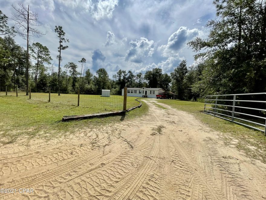 Cute 3/2 Double wide on a beautiful 1.2 acre lot in Fountain with an outbuilding and detached carport. Walls have been taped, textured, and painted, carpet recently cleaned, and has a new well. Very nice little starter home for someone!!! Has central heat and window A/C. Make your appointment to see it now!