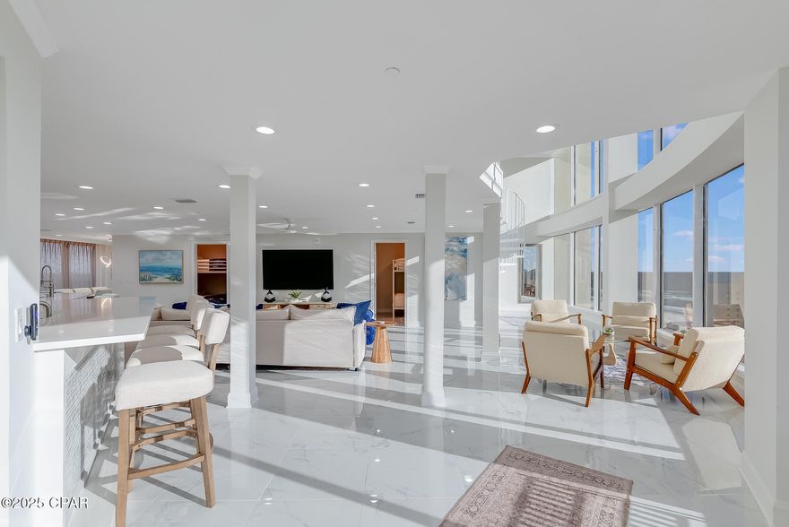 Step into a world of modern coastal luxury with this fully furnished, turn-key Gulf-view residence, built in 2025 and designed to impress at every angle. This expansive 2,882 sq ft, 5-bedroom, 5-bathroom condo at Laketown Wharf showcases a clean, bright, almost futuristic aesthetic with crisp white interiors, soaring floor-to-ceiling windows, and wide open living spaces that feel airy, elevated, and effortlessly refined. Natural light pours in through dramatic walls of glass, allowing the turquoise waters and horizon of the Emerald Coast to become the home's most stunning feature.

Inside, the contemporary design emphasizes simplicity, sophistication, and space. The open living and dining areas create an ideal environment for entertaining or unwinding, while each bedroom offers a peaceful retreat wrapped in calming white tones and curated furnishings. This residence is fully furnished and turn-key, providing a seamless luxury lifestyle from the moment you arrive.

Laketown Wharf elevates the experience with multiple resort-style pools, a modern fitness center, on-site dining and shopping, a scenic lakeside boardwalk, covered parking, and 24-hour security. Direct beach access is moments away, making it easy to enjoy the sugar-white sand and emerald waters at your leisure.

Whether you're searching for a striking modern beach home or an exceptional high-performing rental property, this 2025-built condo offers unmatched versatility, style, and income potential. This is coastal luxury reimagined, bright, modern, spacious, and truly one of a kind.