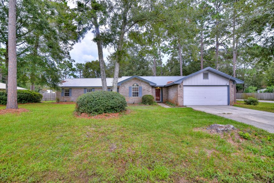 Amazing 3 bedroom 3 bath home with 2 master suites on a corner lot in Lynn Haven with a 2 car garage and metal roof in 2015! Interior has been freshly painted, new carpet, laminate flooring in all main areas and master. Kitchen features stainless steel appliances, undermount sink, and granite countertops. Master addition has a 13x13 bonus room (nursery/office/sitting area with closet), deck off of the master bedroom, 2 large walk in closets, double vanity, large tub, and separate shower.  2nd master bedroom has new carpet, walk in closet, and full bathroom. Spacious 3rd bedroom, large yard, back patio, and much more! All sizes, measurements, and info is approximate, please verify if important.